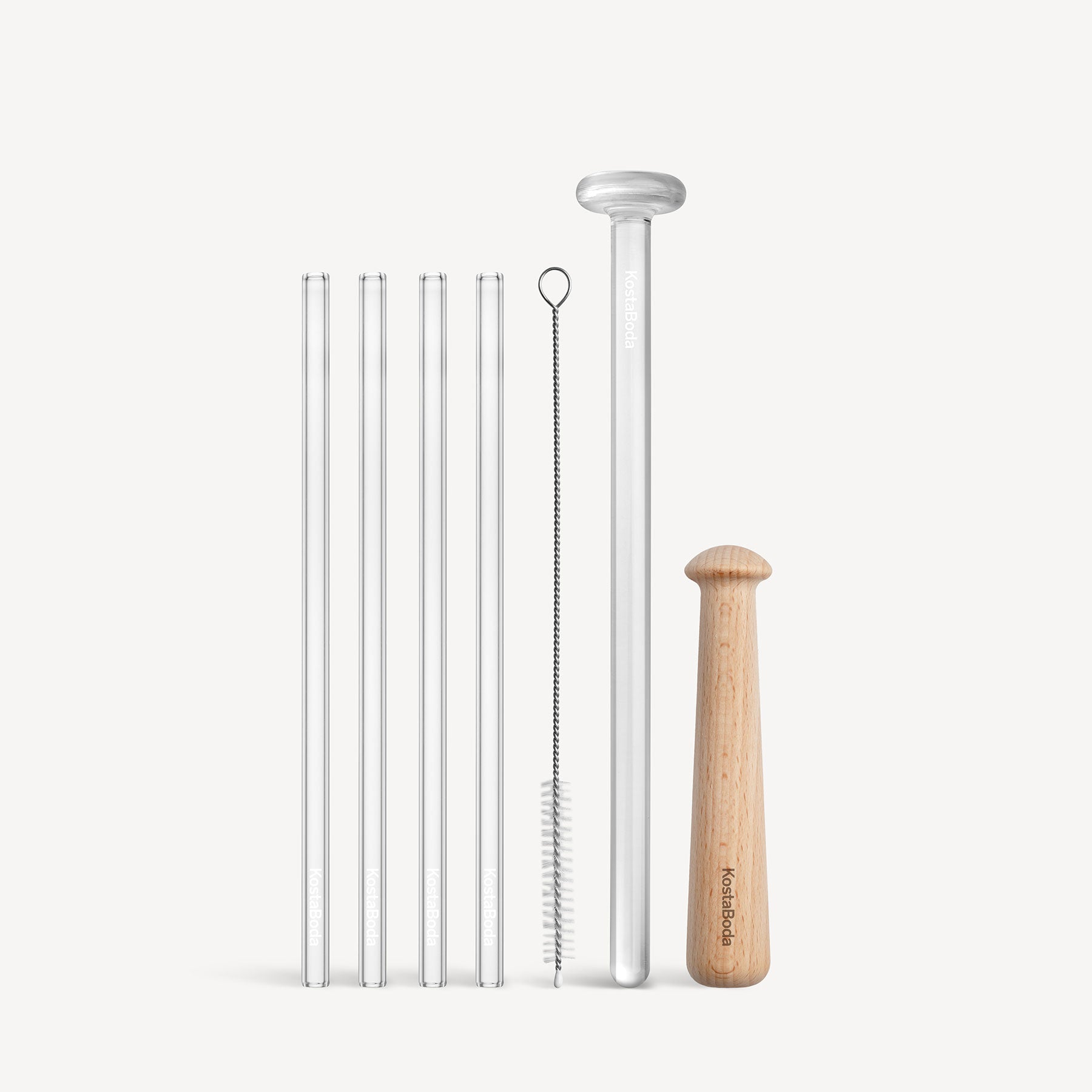 Set of reusable straws with a cleaning brush and holder on a white background