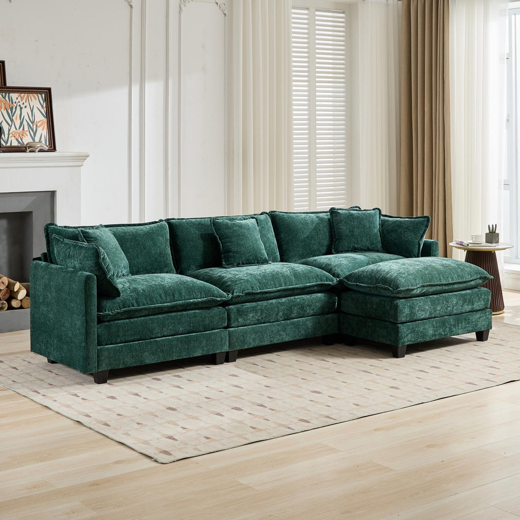 Green sectional sofa in a living room setting with a fireplace and curtains.