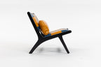 Modern chair with black frame and orange cushions on a white background