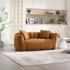 Brown sofa in a modern living room with a rug and decorative items.
