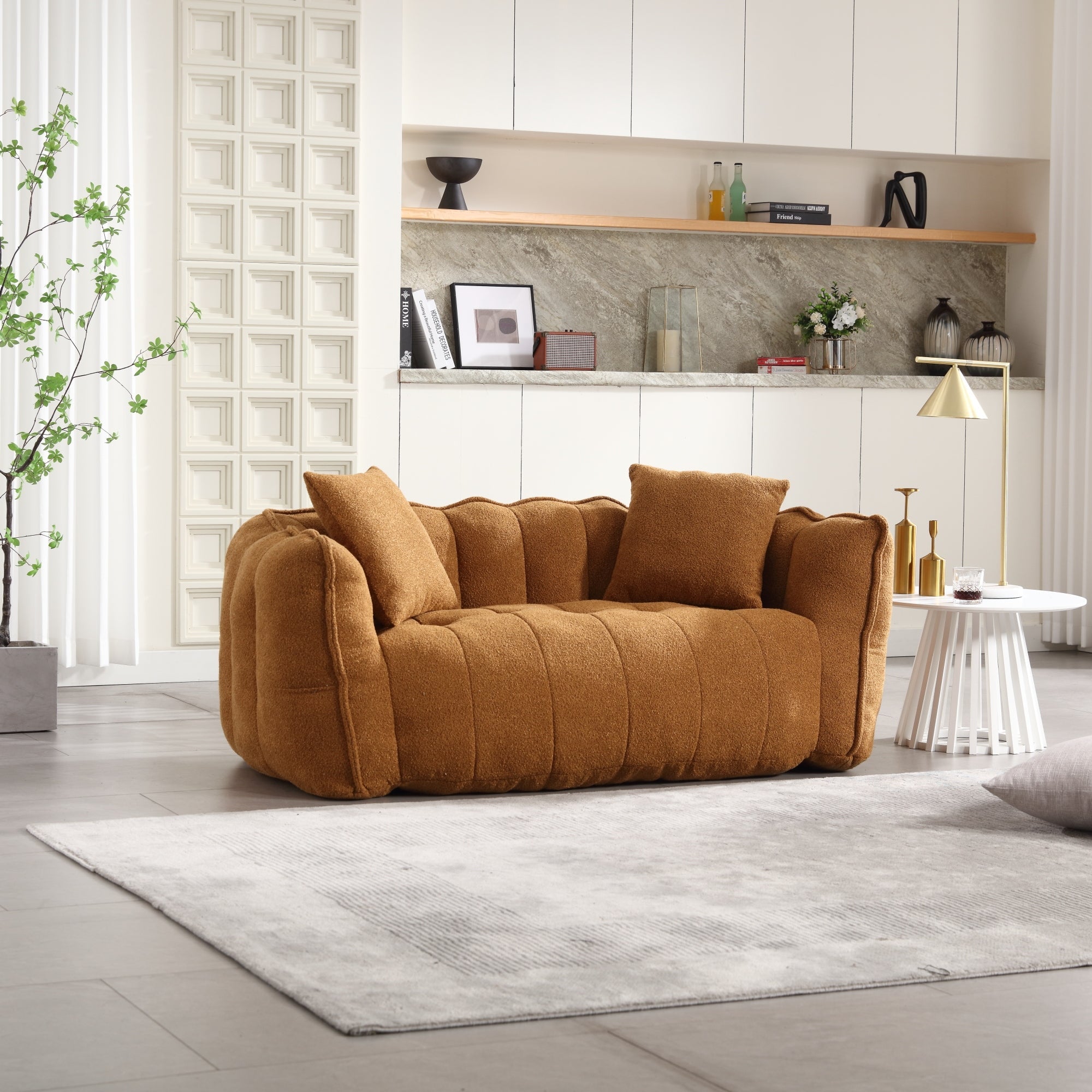 Brown sofa in a modern living room with a rug and decorative items.