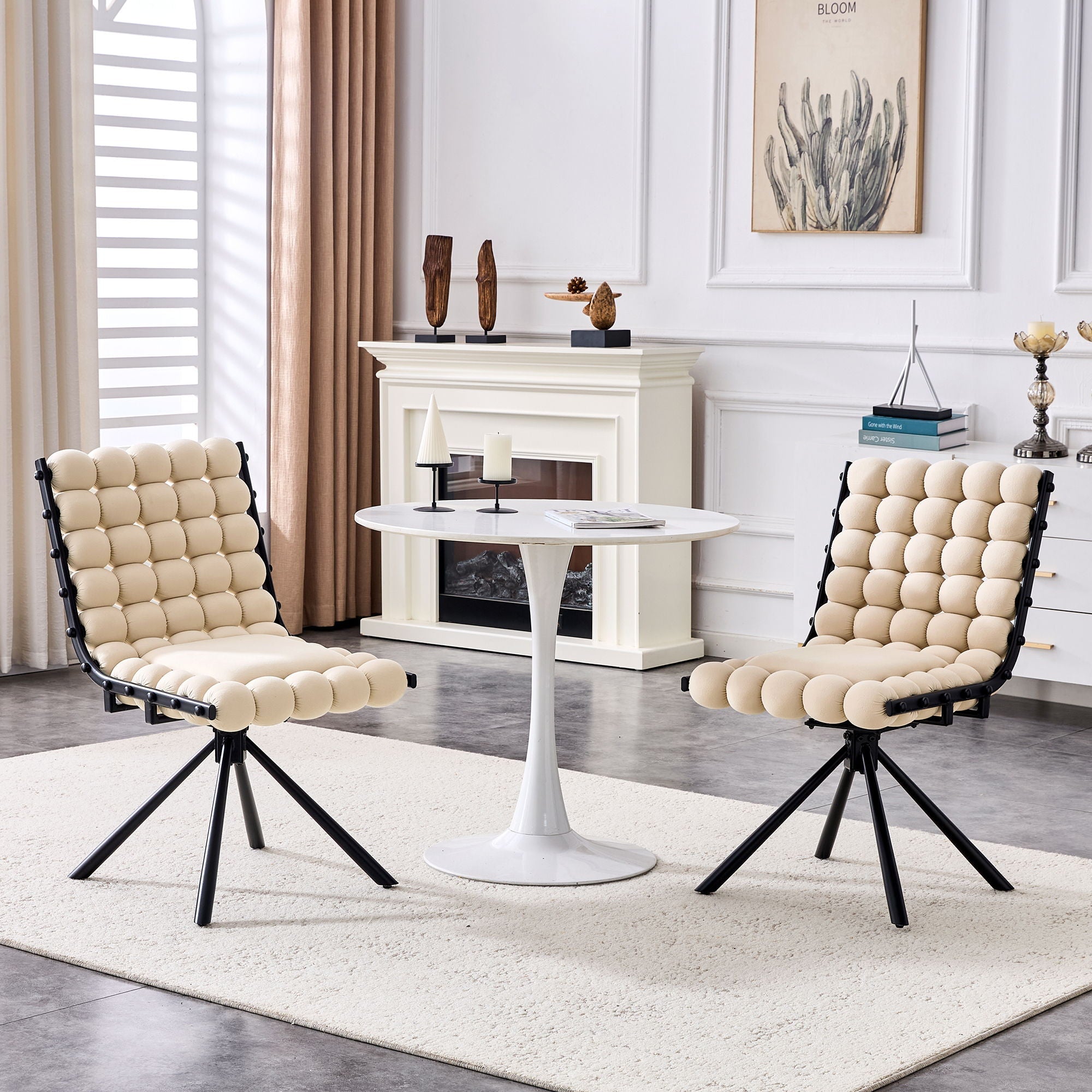 Modern living room with two beige chairs and a white table.