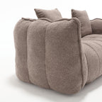 Brown textured sofa with cushions on a white background