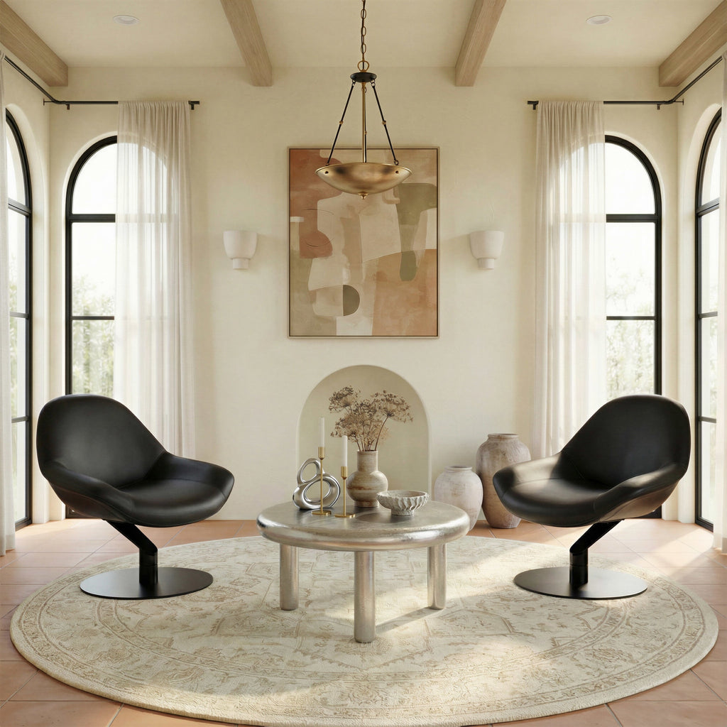 Modern living room with black chairs, round table, and abstract art on the wall.