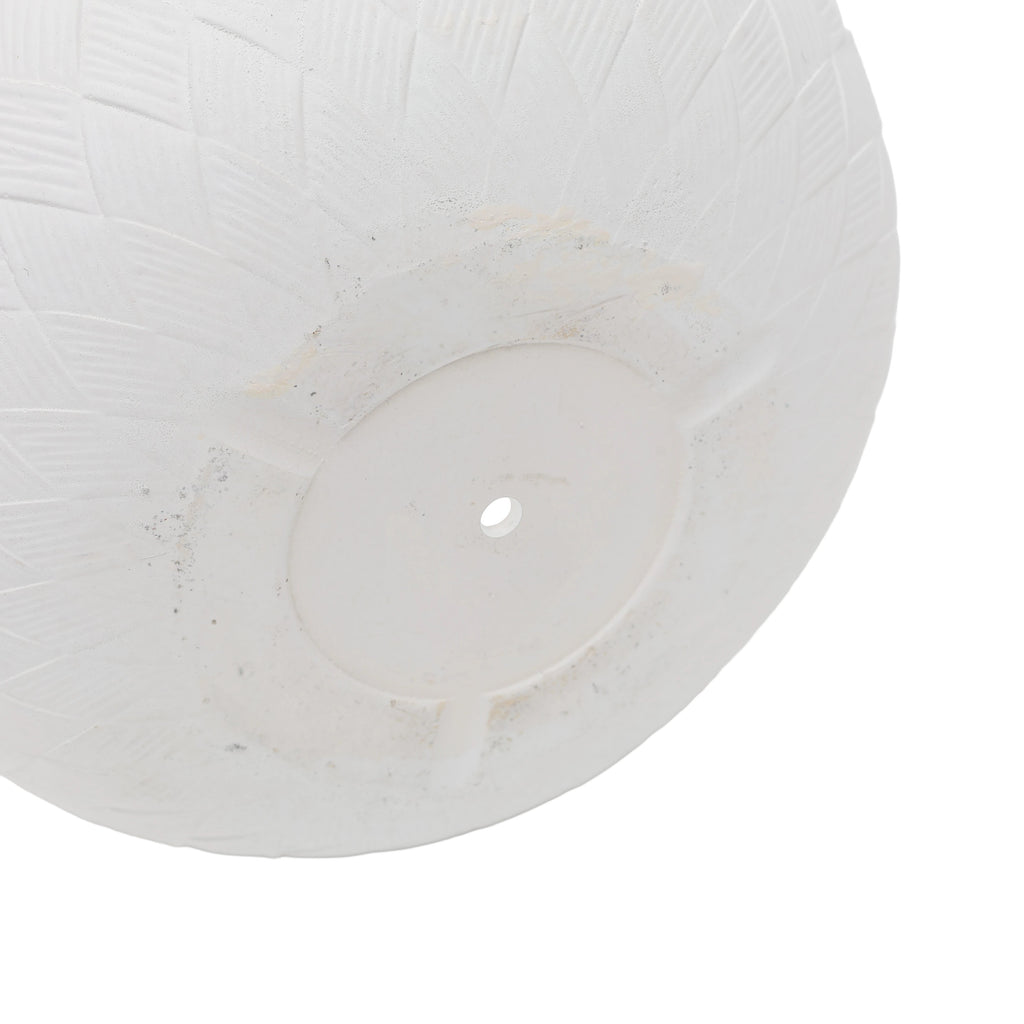 Close-up of a white planter bottom with a hole with a textured basketweave pattern on a white background.