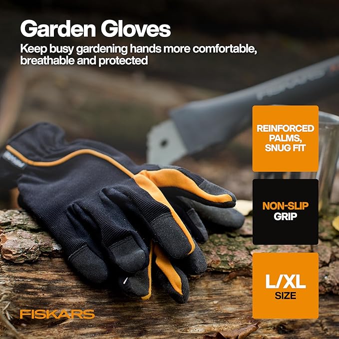 Garden gloves with Fiskars branding on a wooden surface with gardening tools in the background.