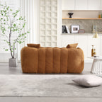 Brown sofa in a modern living room with a plant and decorative items.