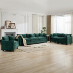 Green velvet sofa set in a living room with wooden floor and large windows.