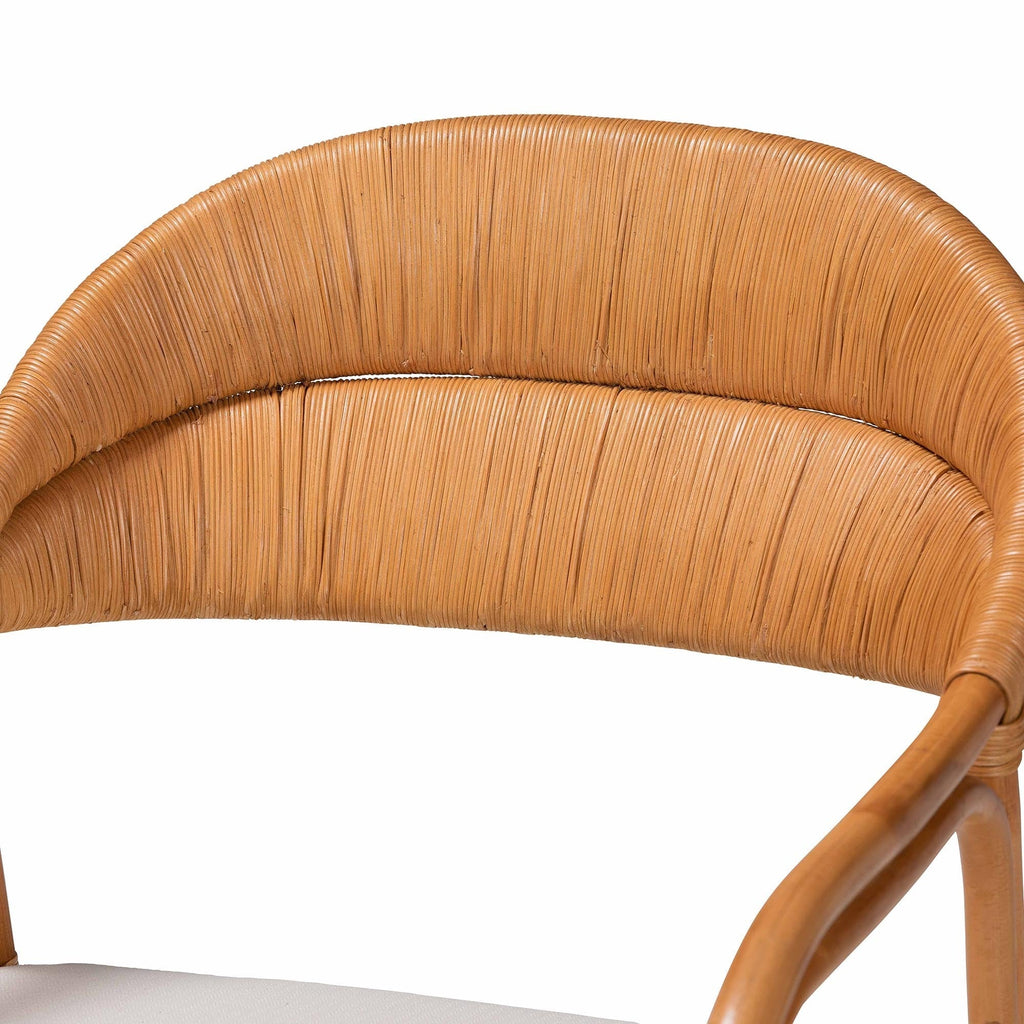 Close-up of a wicker chair with a white cushion on a white background