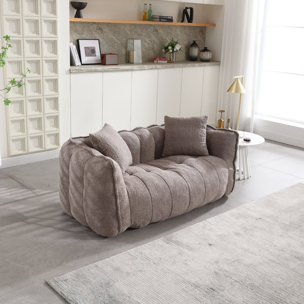 Gray sofa in a modern living room with a neutral color palette.
