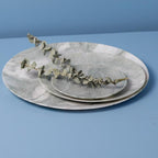 Set of marble plates with a branch on a blue background
