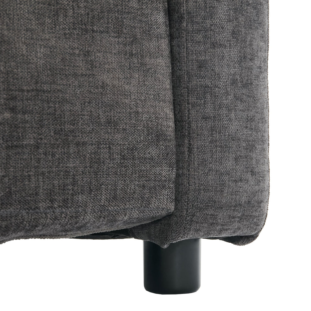 Close-up of a gray upholstered chair corner with a black leg on a white background