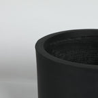 Black cylindrical planter on a light gray background