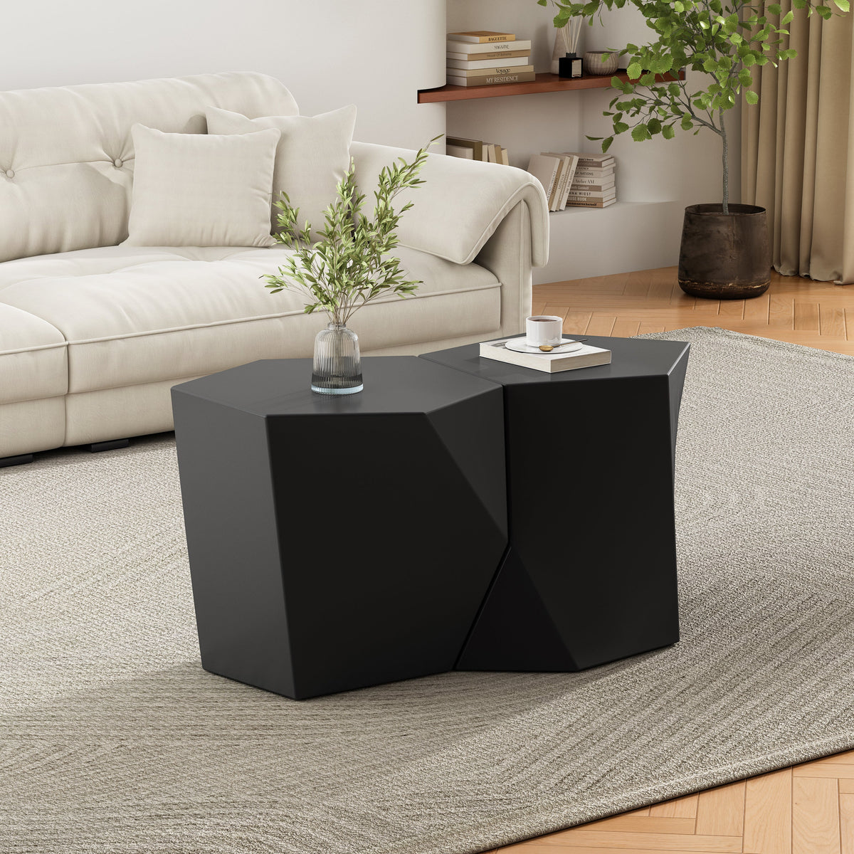 Modern black coffee table in a living room setting with a sofa and decor items.