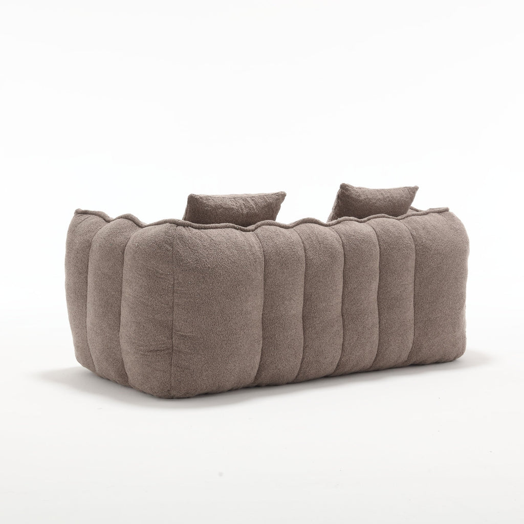 Brown textured sofa with cushions on a white background