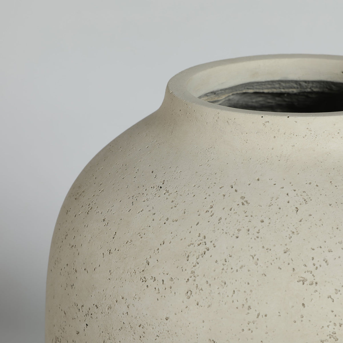 Close-up of a textured ceramic vase on a plain background