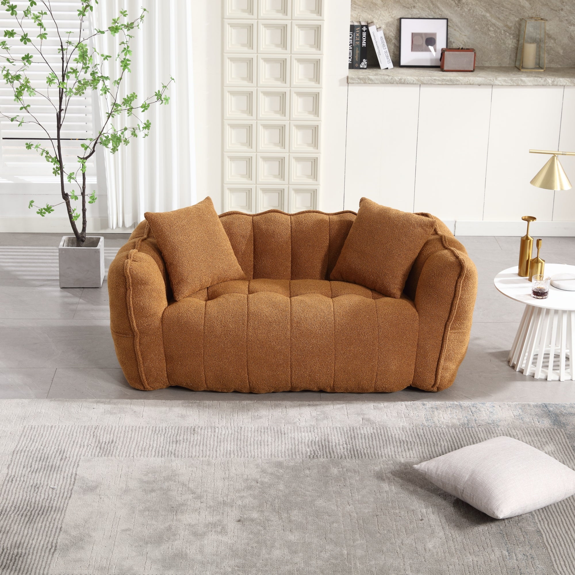 Brown sofa in a modern living room with a plant and side table.