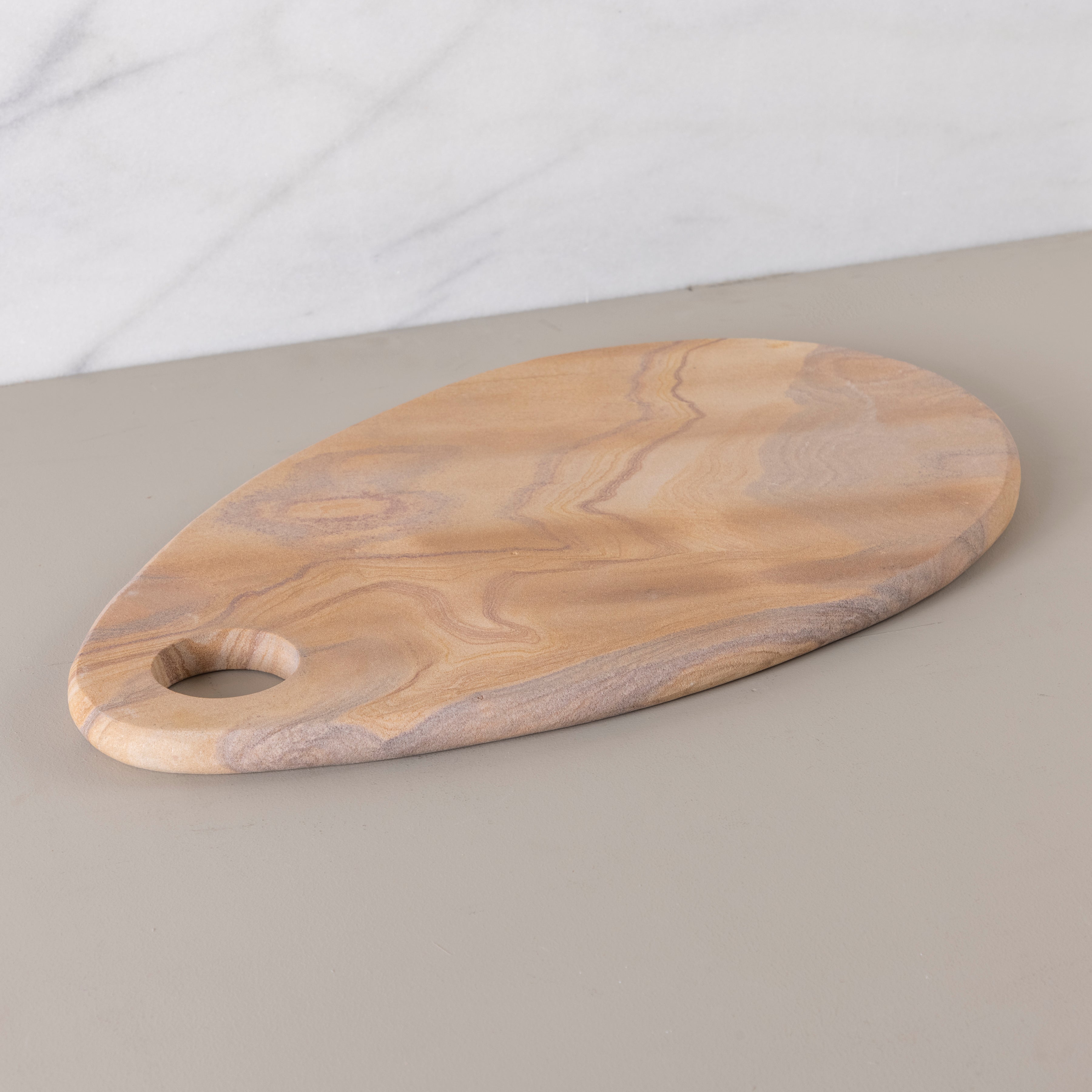 Wooden cutting board on a neutral background