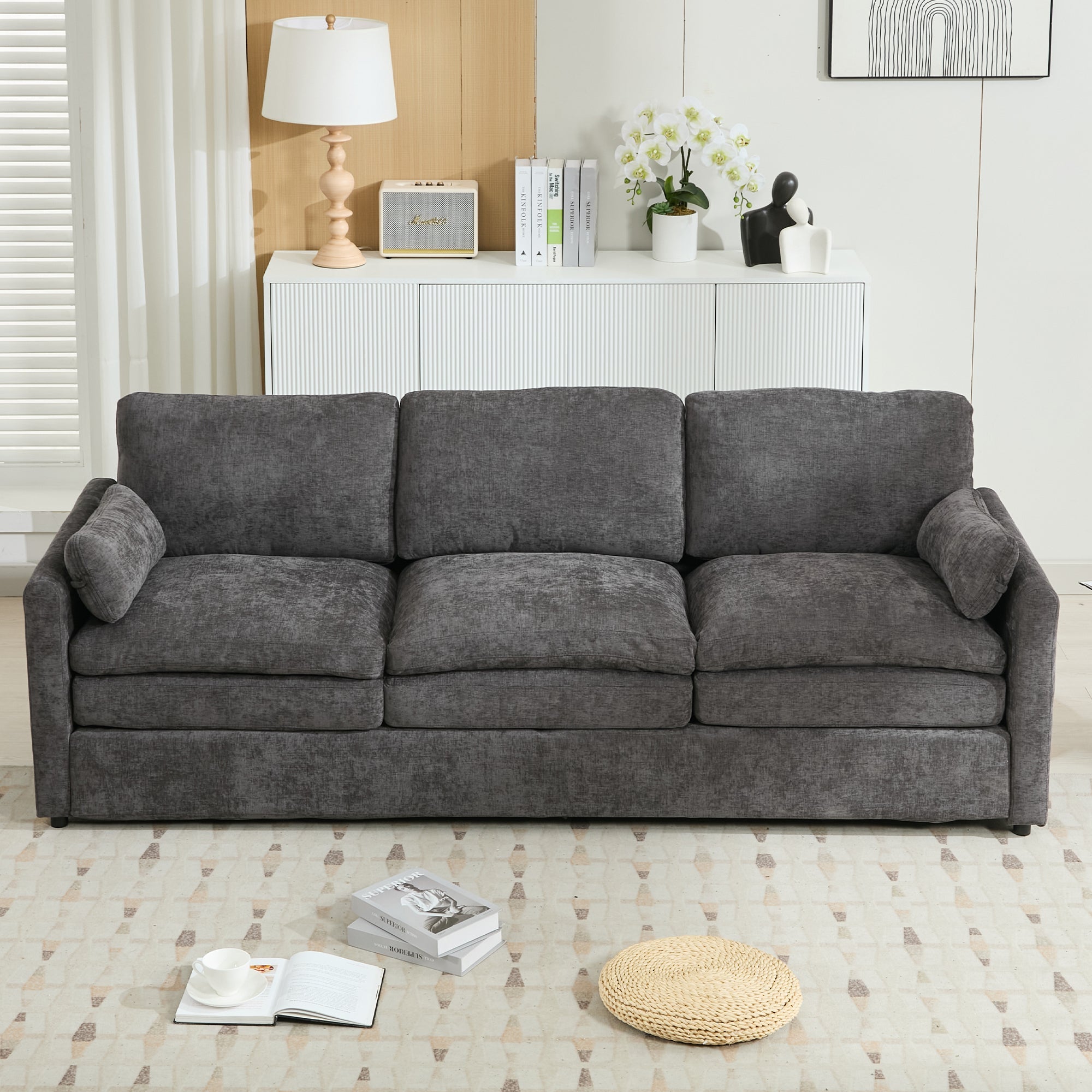 Gray sofa in a living room setting with decor items.