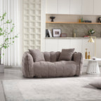 Gray sofa in a modern living room with a kitchen in the background
