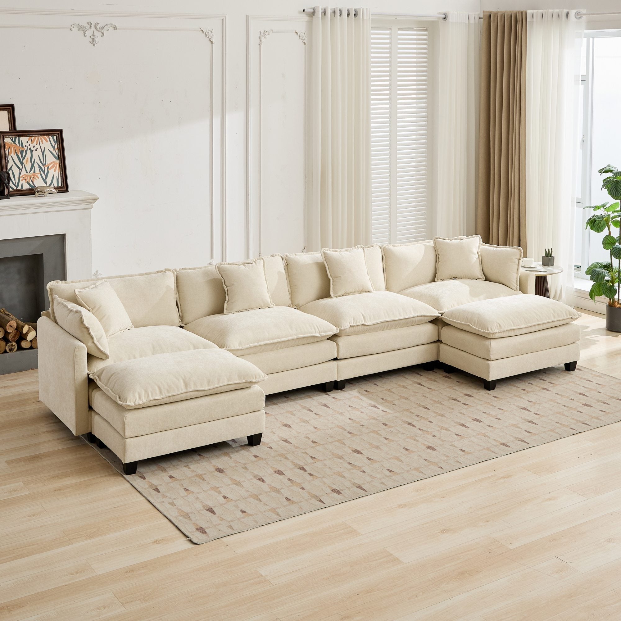 Beige sectional sofa in a living room with wooden floor and large windows.