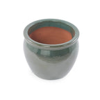 A small round ceramic pot with a glossy dark green glazed exterior and a terracotta-colored interior, shown on a plain white background.