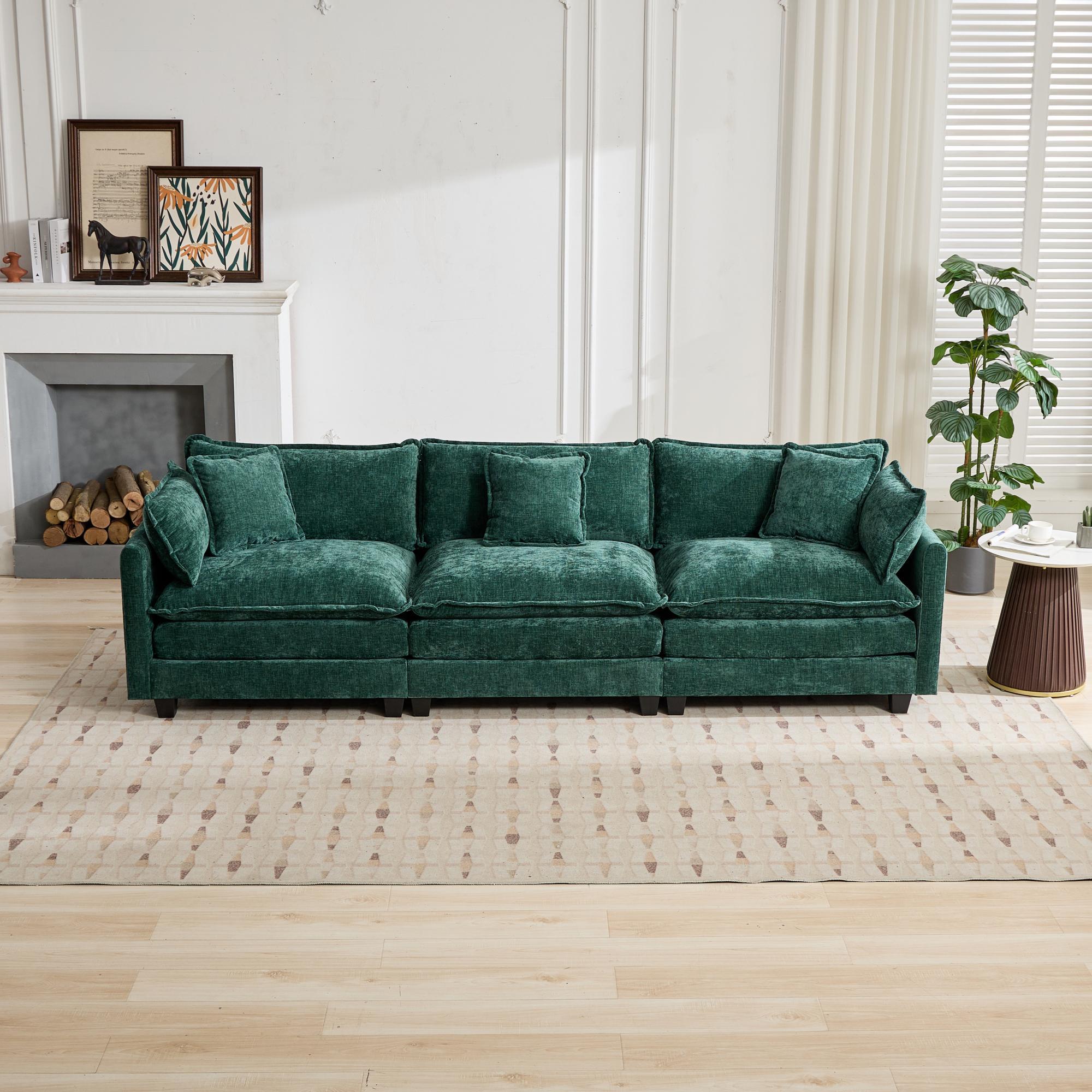 Green sofa in a living room setting with a fireplace and decor.