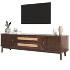 A mid-century modern wooden TV stand console in dark brown wood with two drawers featuring woven cane fronts and fluted side panels, styled with decorative vases and a book on a white background.