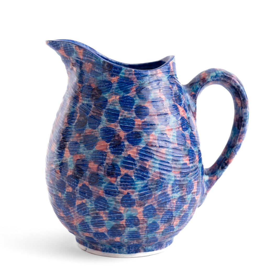 Ceramic pitcher with blue and pink speckled pattern on a white background