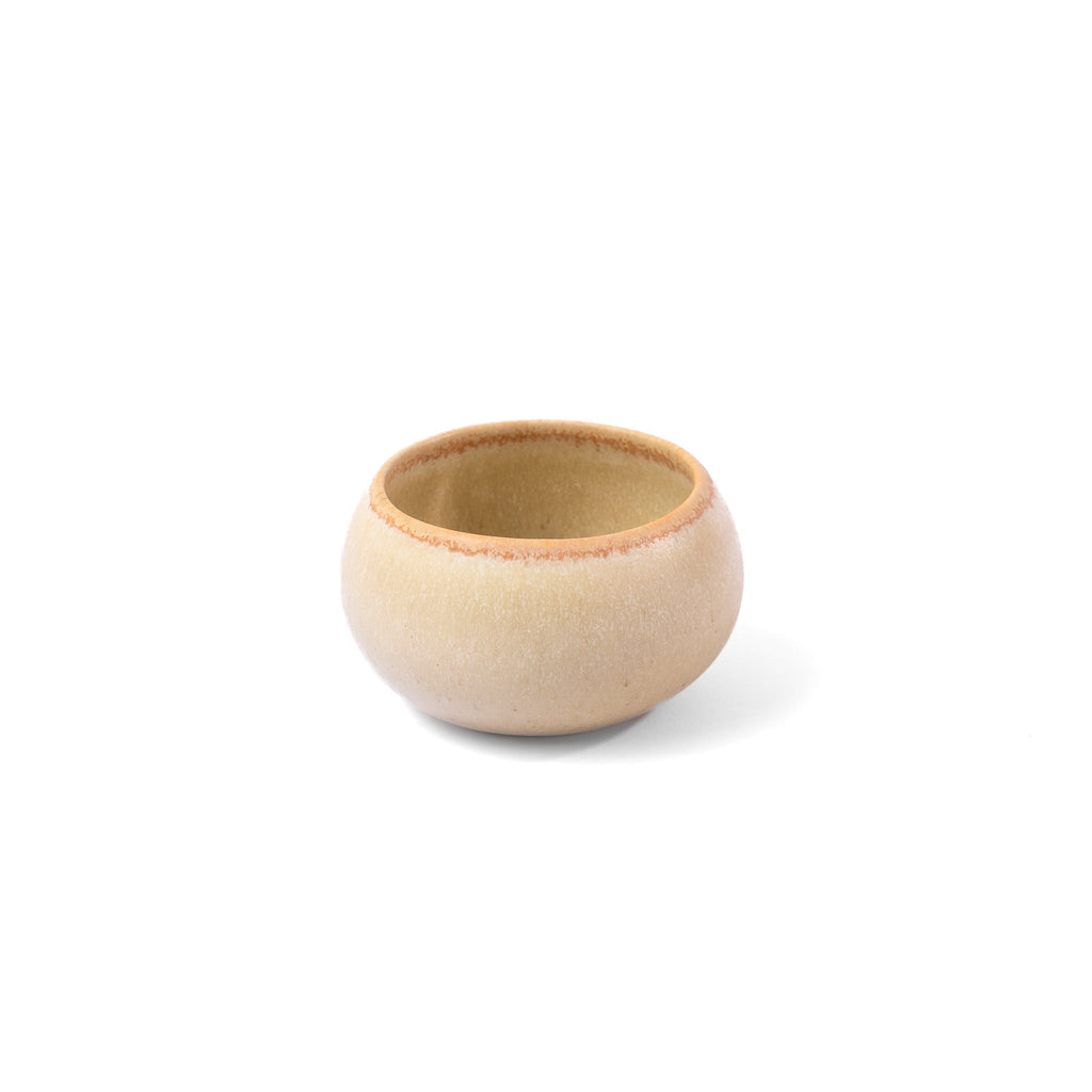 Small beige ceramic bowl on a white background
