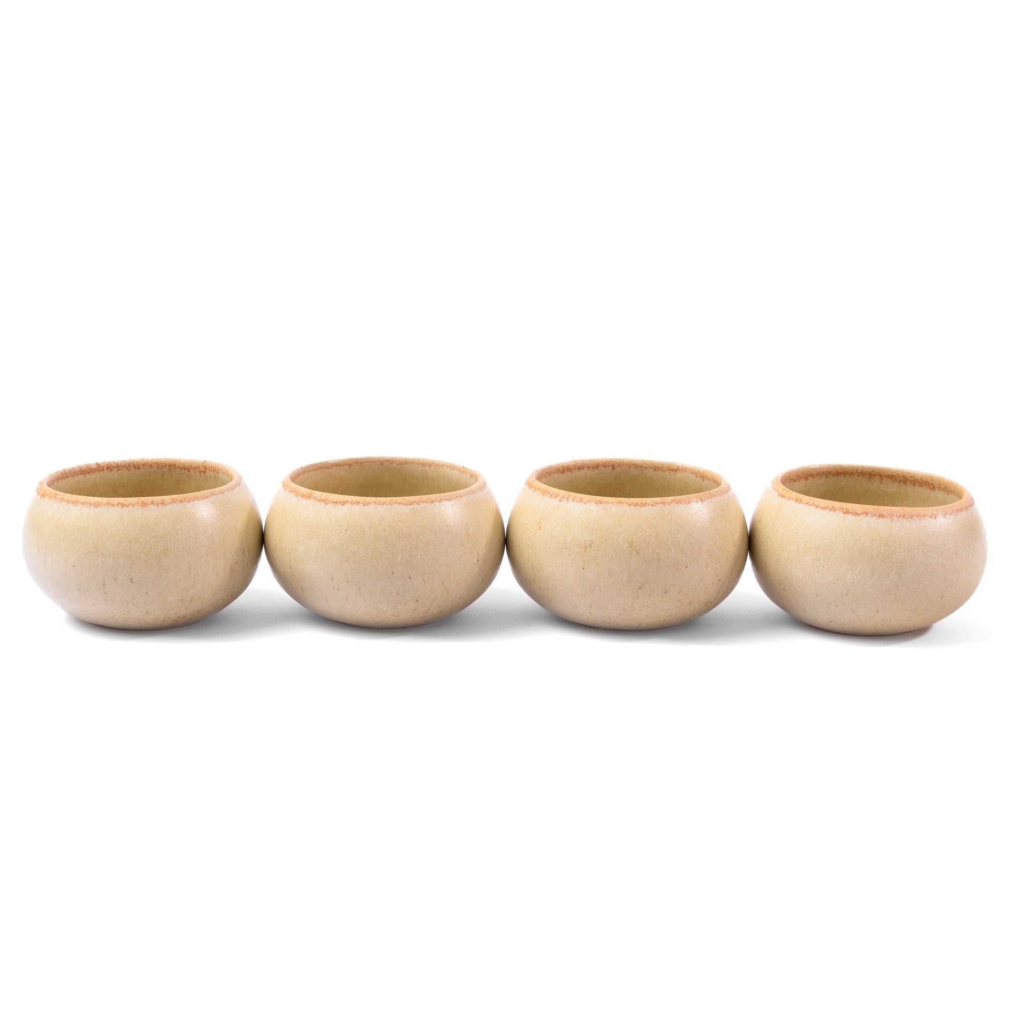 Four beige ceramic cups arranged in a row on a white background
