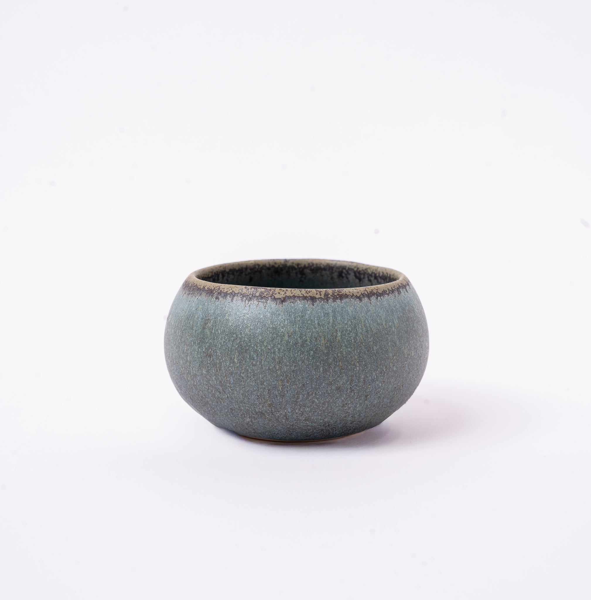 Small ceramic bowl with a textured surface on a white background