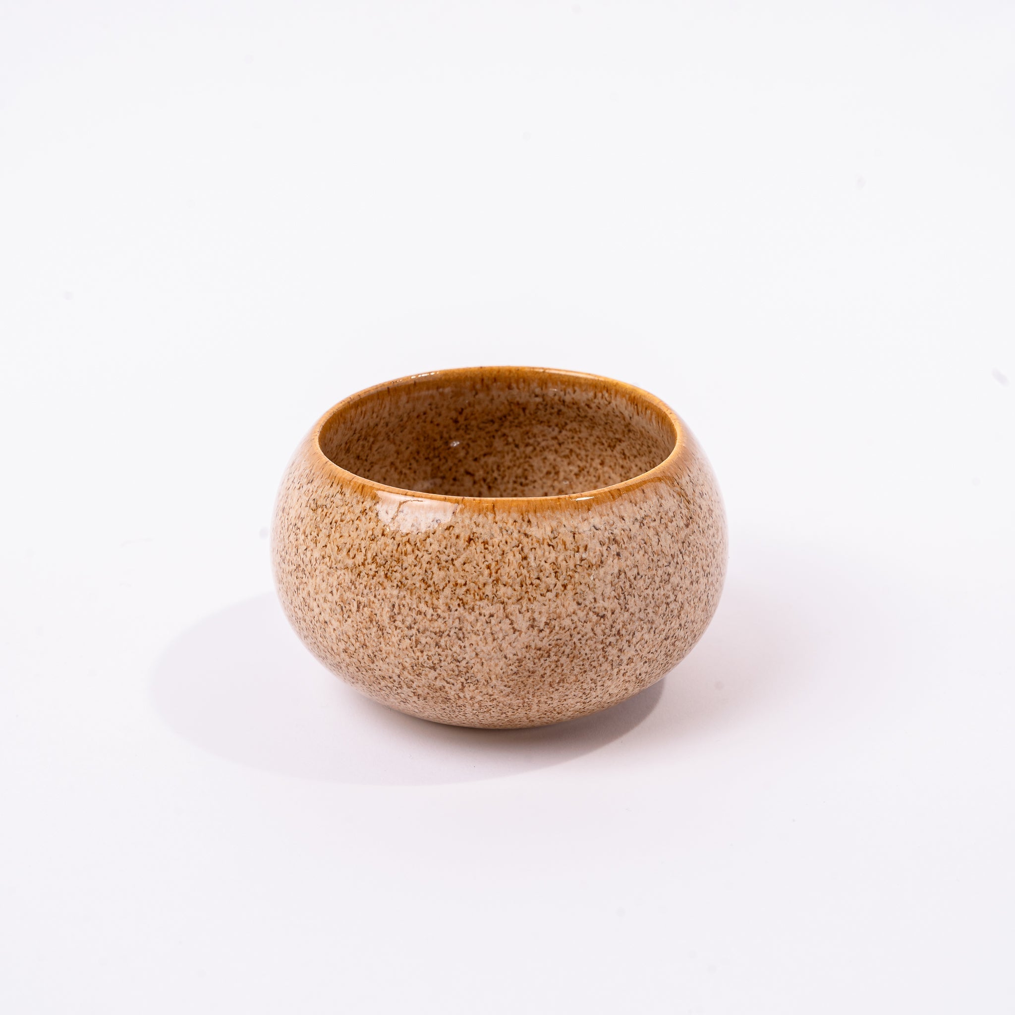 Small ceramic bowl smooth with a textured pattern on a white background