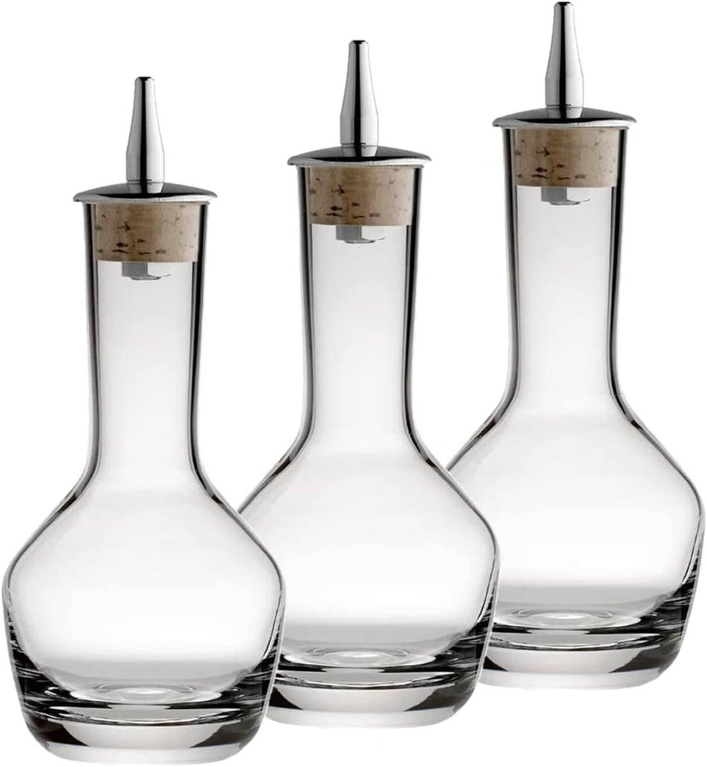 Set of three clear glass decanters with silver nozzles on a white background