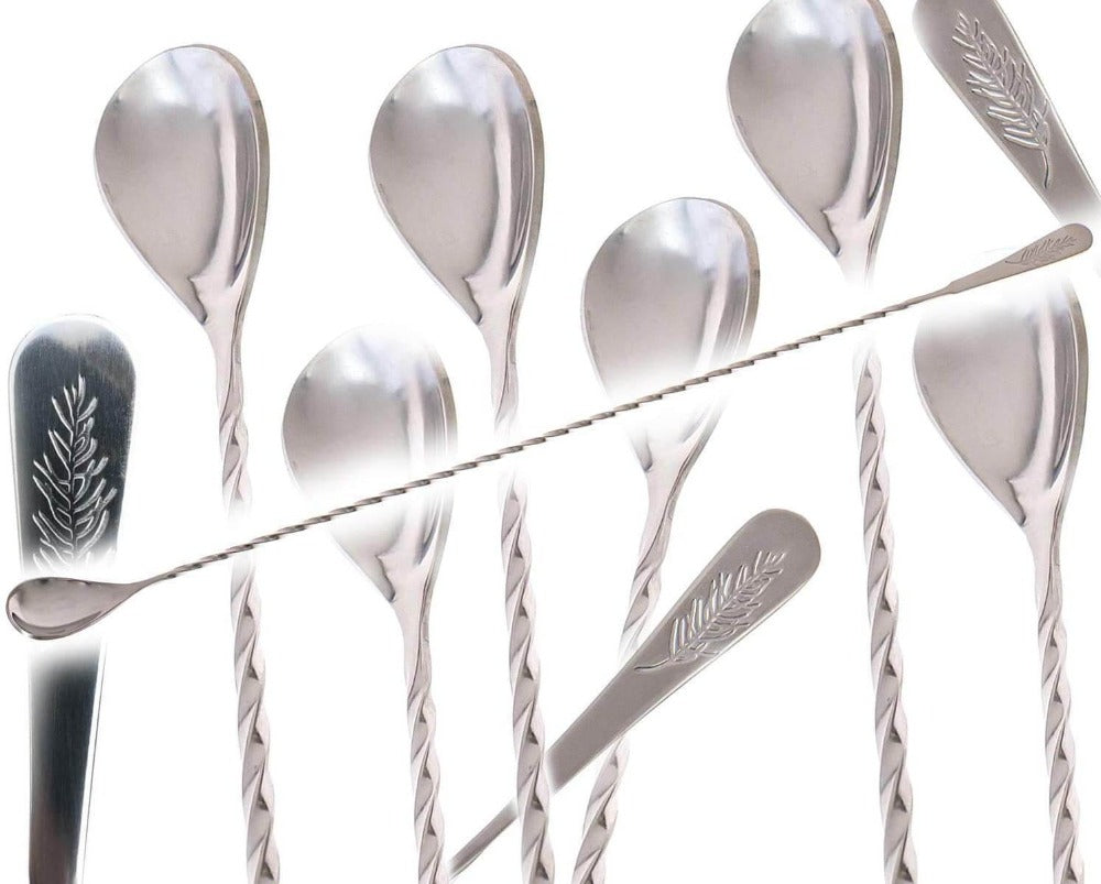 Set of silver spoons with different designs on a white background