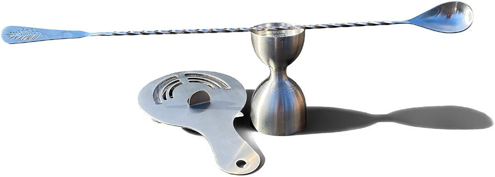 Metallic cocktail shaker and strainer on a white background