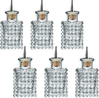 Set of six diamond-patterned glass bottles with cork stoppers on a white background