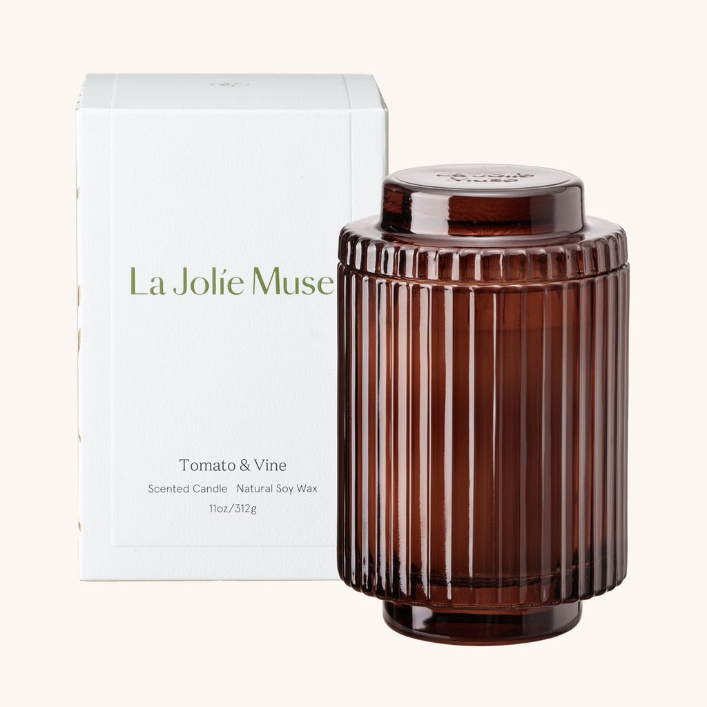 Brown ribbed candle with 'La Jolie Muse' packaging on a white background