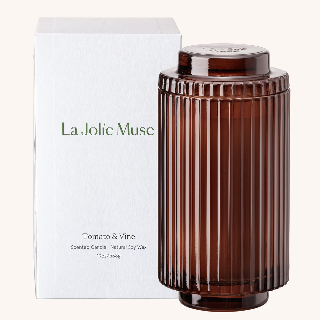 Brown ribbed candle with 'La Jolie Muse' packaging on a white background