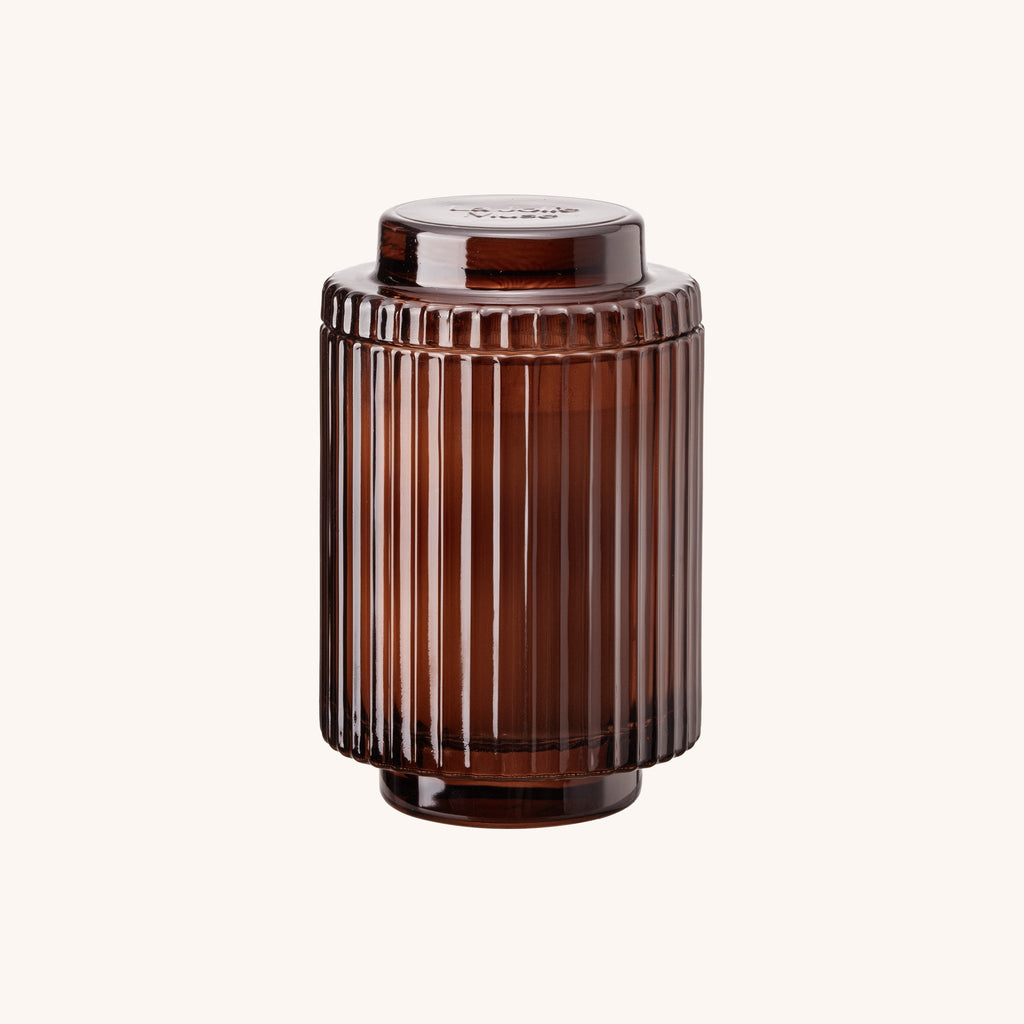 Brown ribbed cylindrical container on a white background