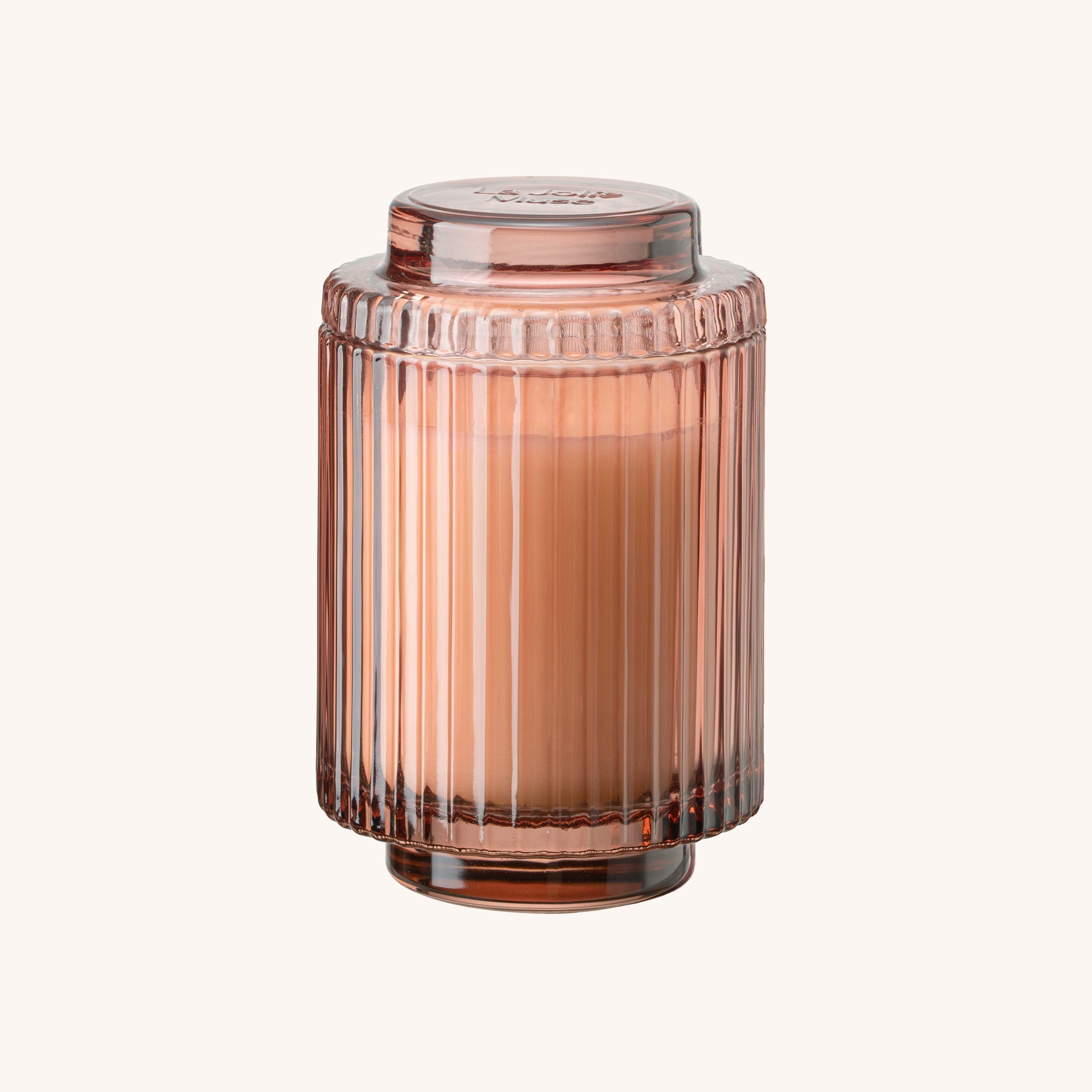 Rose gold ribbed glass jar on a white background