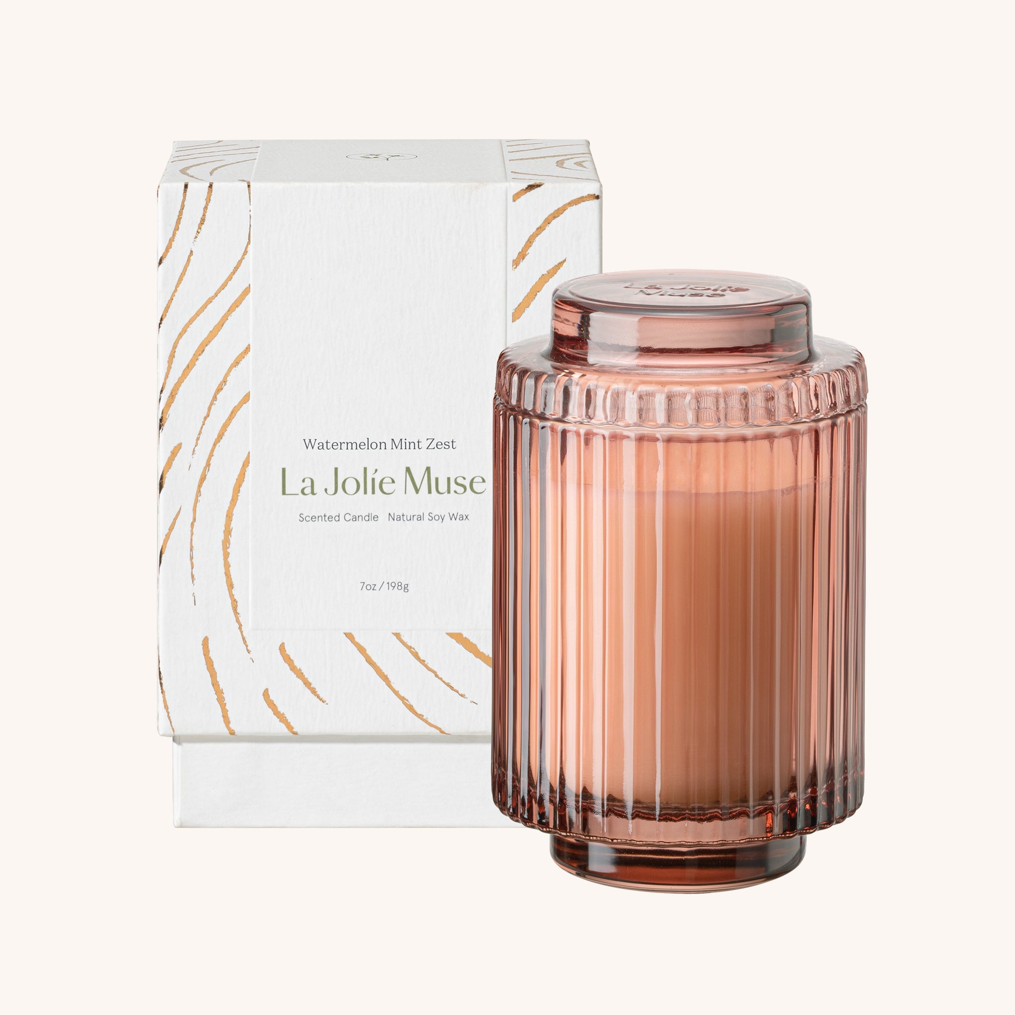 Rose gold candle with packaging labeled 'La Jolie Muse' on a white background