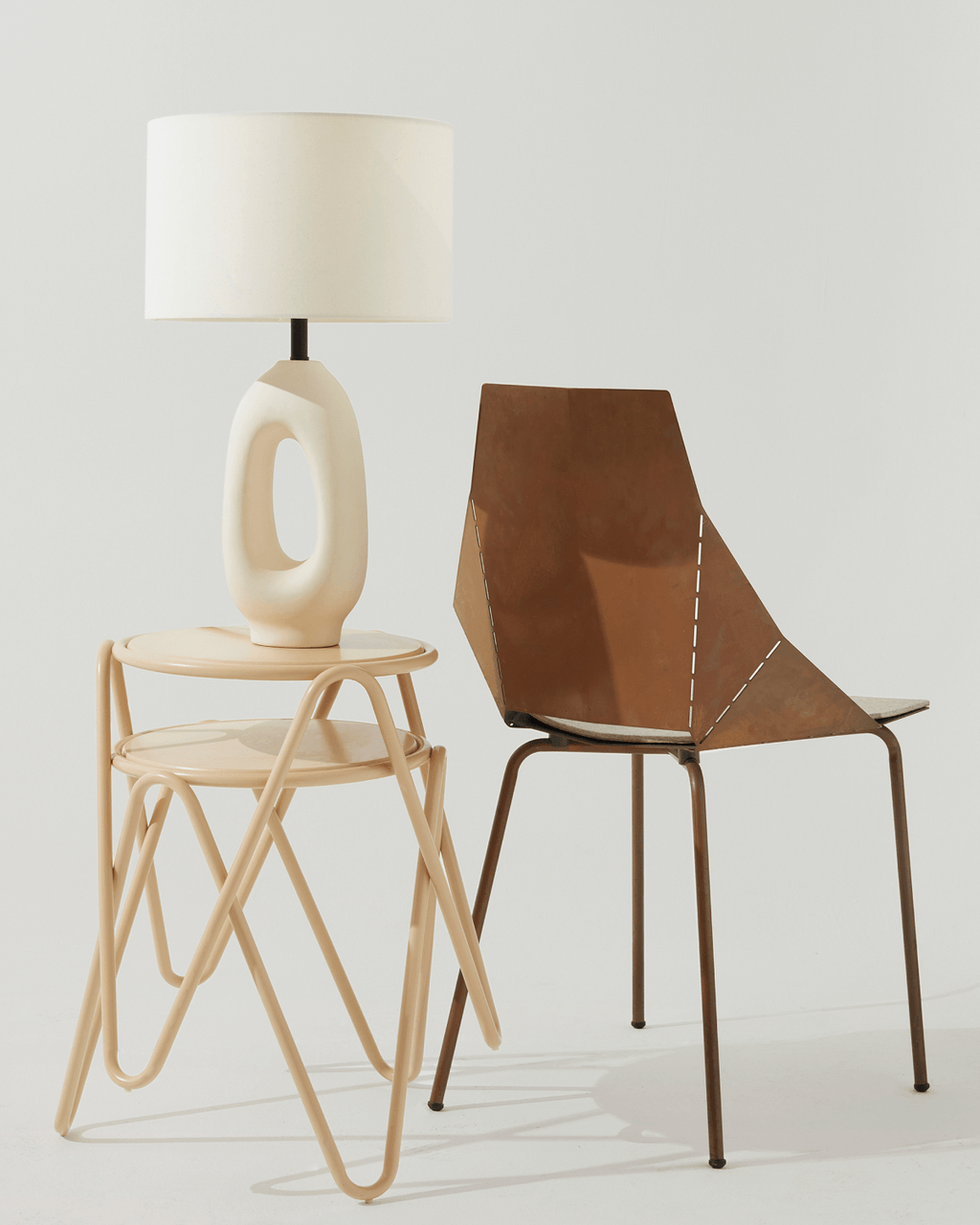 A modern chair and a lamp on a light gray background