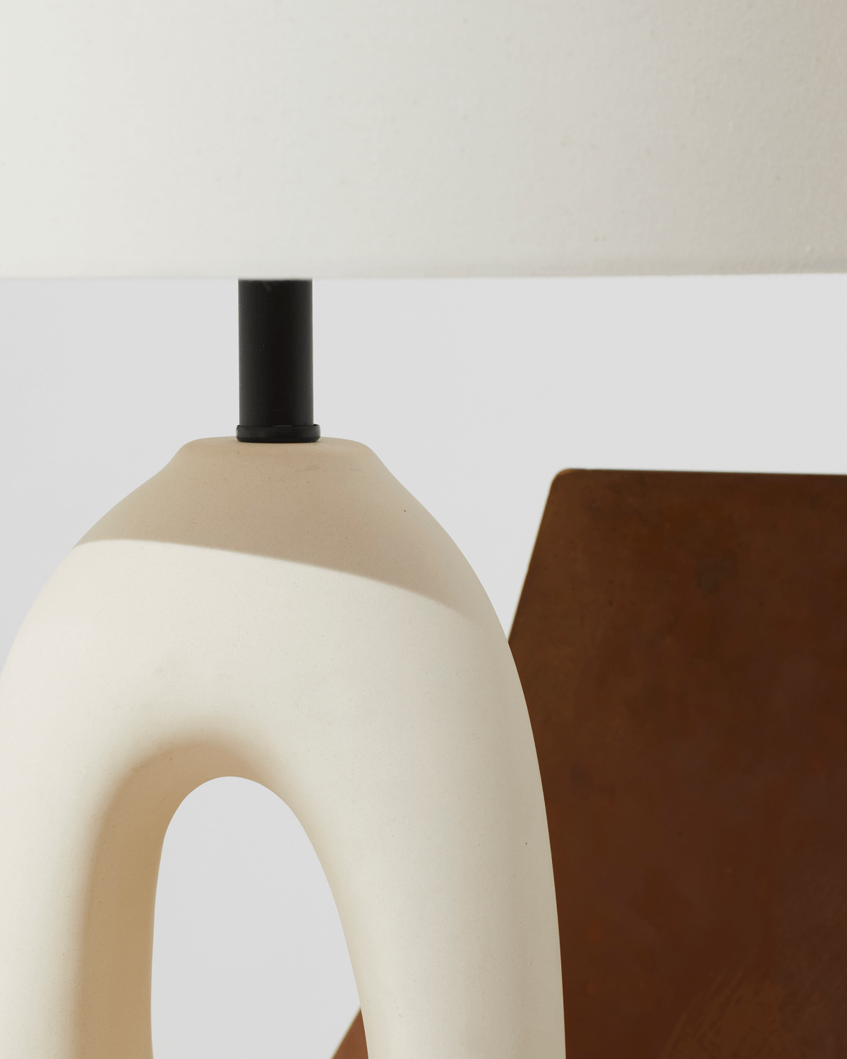 Modern lamp with beige and white design on a neutral background
