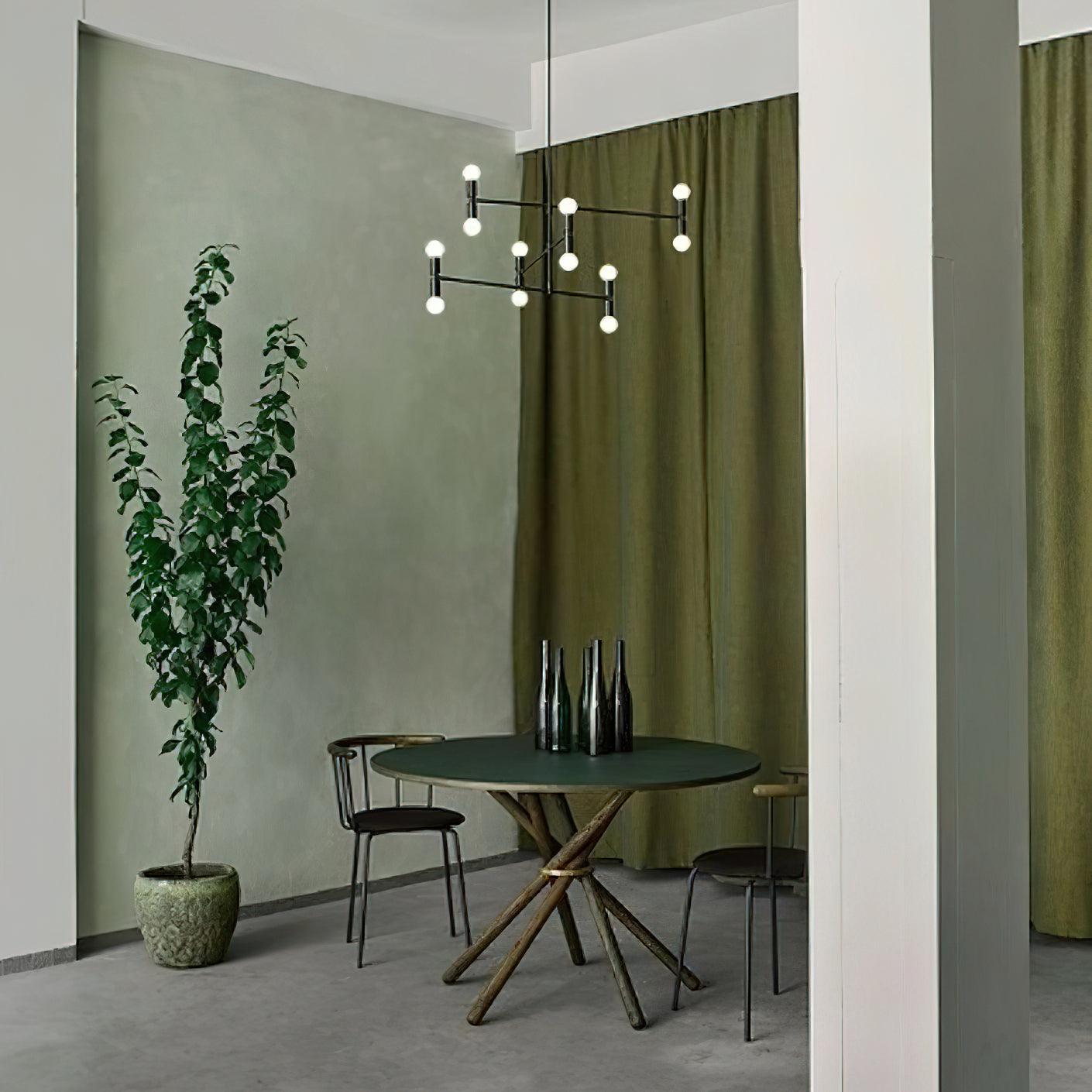 Modern dining room with a round table, chairs, and a potted plant.