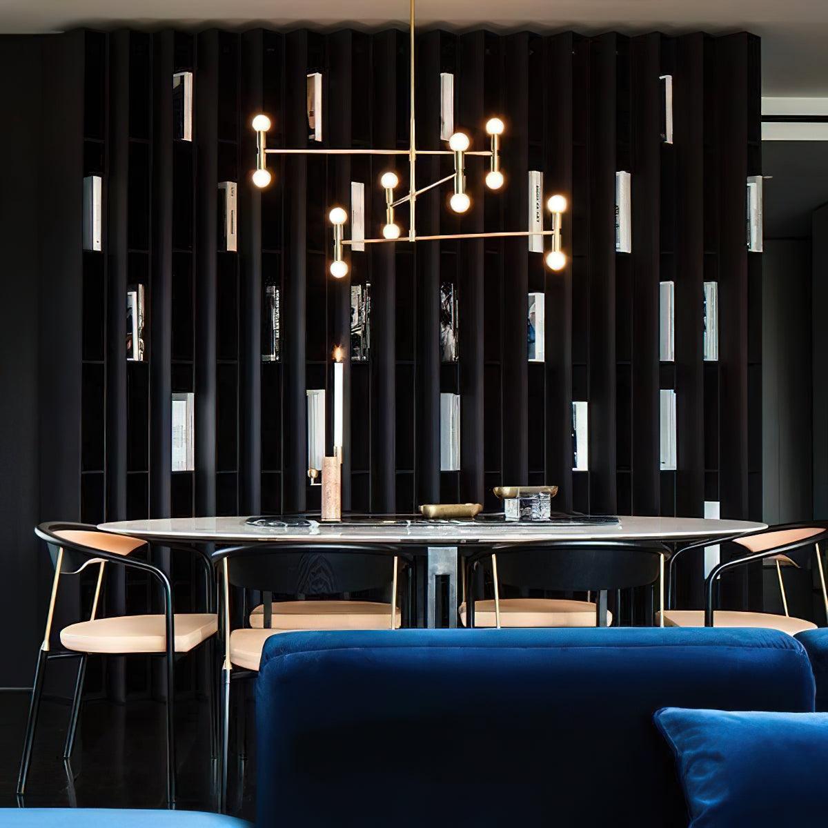Modern dining room with a chandelier, round table, and blue sofa.