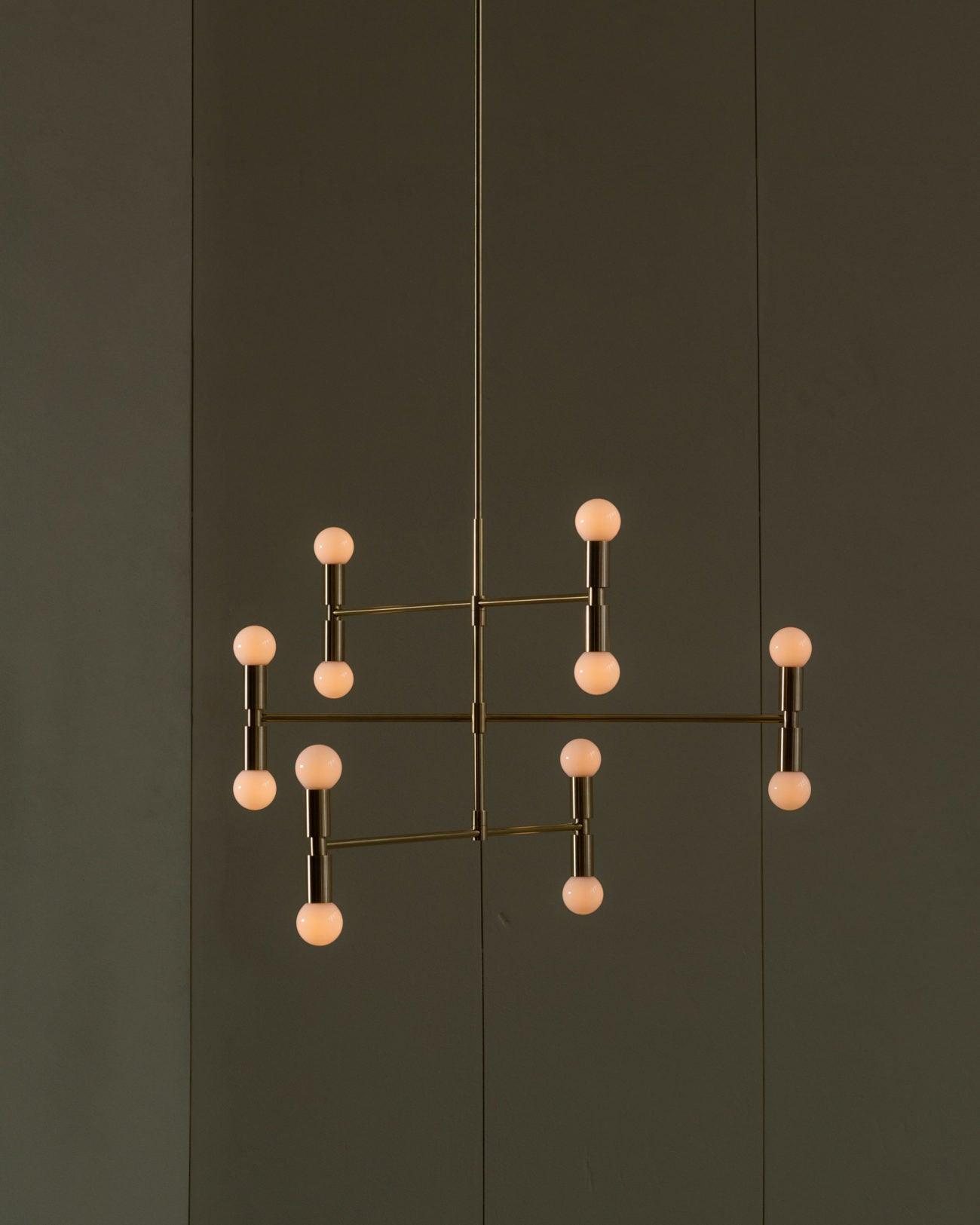 Modern chandelier with spherical bulbs on a dark wall