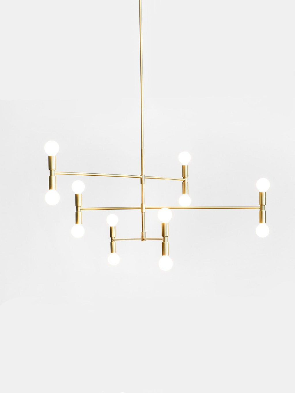 Modern gold chandelier with multiple light bulbs on a white background