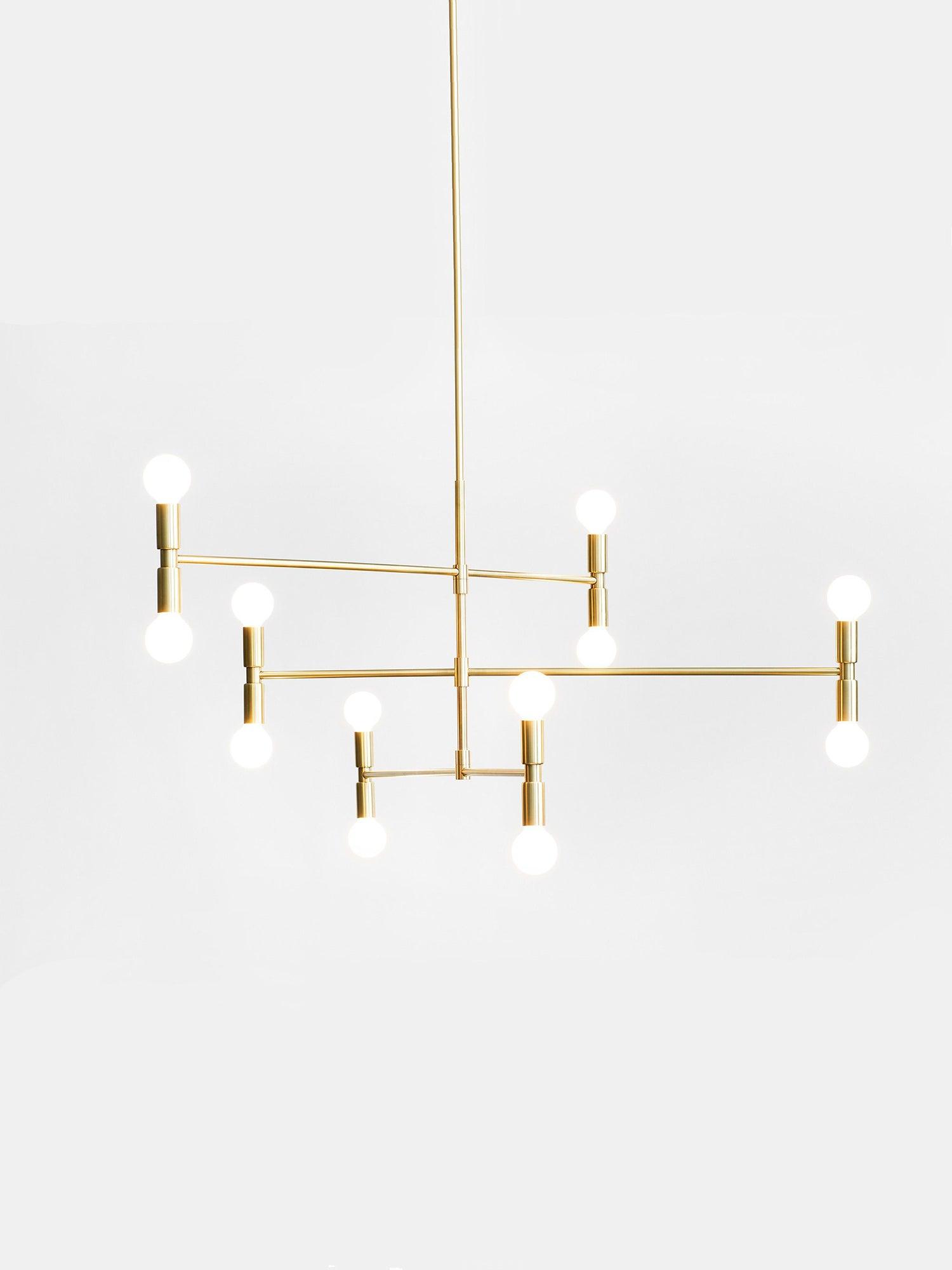 Modern gold chandelier with multiple light bulbs on a white background
