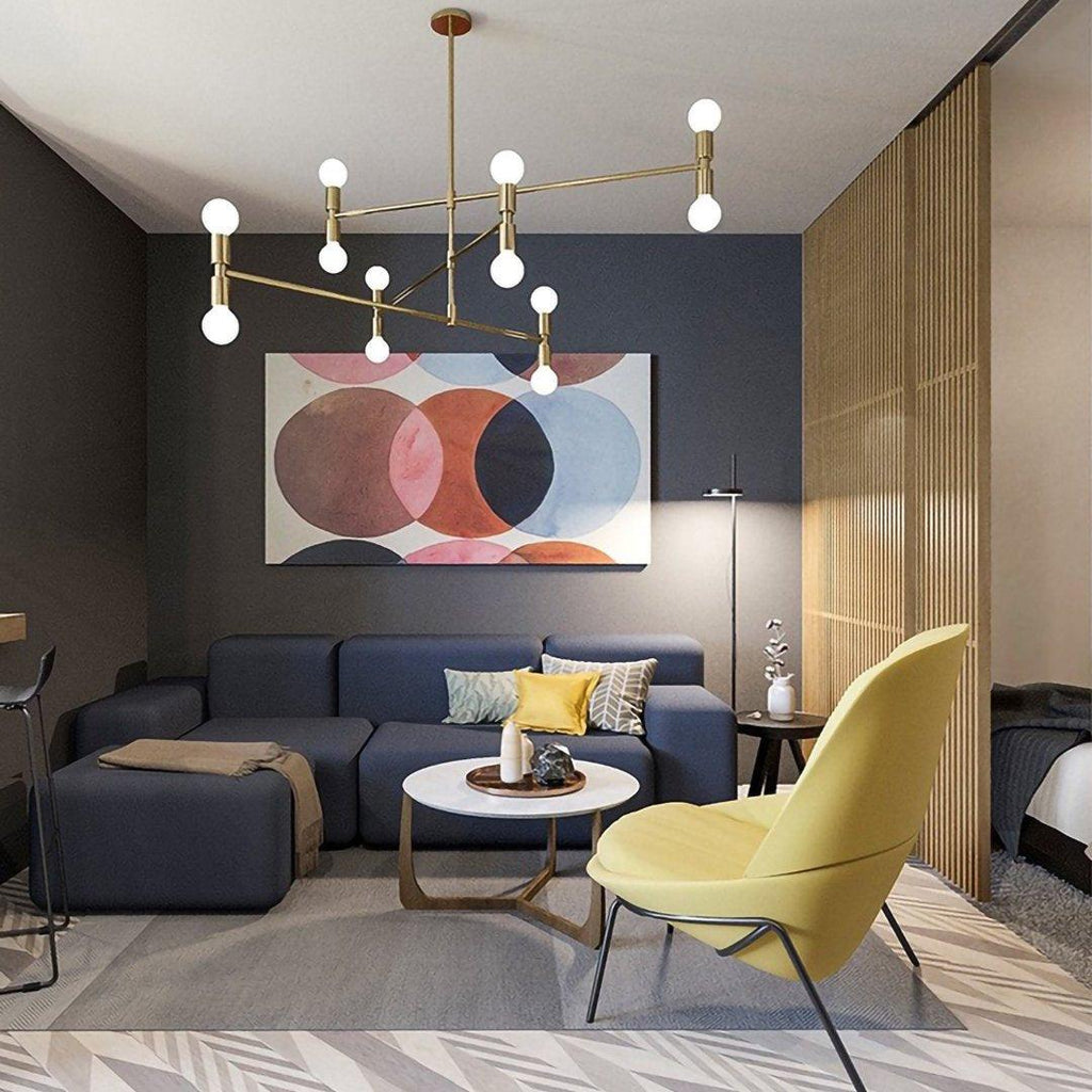 Modern living room with a blue sofa, yellow chair, and abstract art on the wall.
